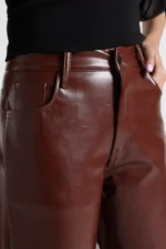 Woman wearing high-waisted black faux leather pants