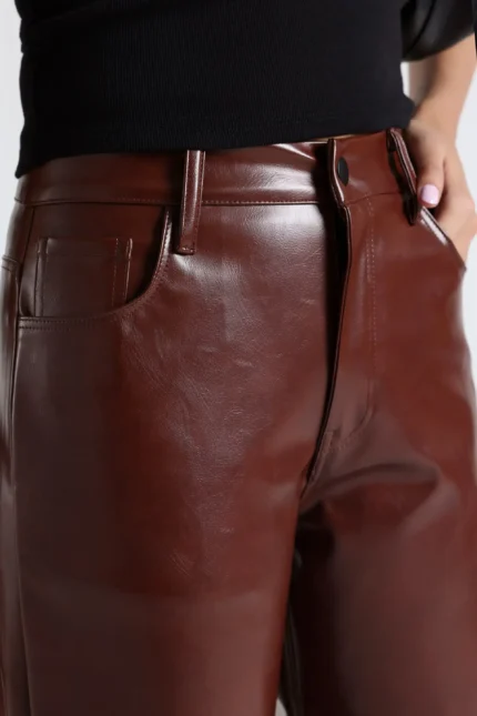 Woman wearing high-waisted black faux leather pants